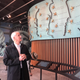 Exhibit designer Edwin Schlossberg explains the donor wall.
